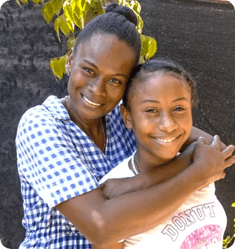 Women hugging a young woman, all smiling. We find the best ideas, initiatives, or projects, strengthen them to create positive change, and empower them to multiply impact together. One Social Investment team collaborating on a social impact investment project.